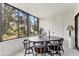 Enclosed Florida room featuring a dining table with a full window view of tropical foliage at 542 Lakeside Dr # 542, Bradenton, FL 34210
