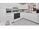 Bright kitchen with white cabinets, modern appliances, and tile flooring for a clean, contemporary aesthetic at 542 Lakeside Dr # 542, Bradenton, FL 34210
