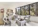 Inviting sunroom with neutral decor and large windows offering a view of the trees at 542 Lakeside Dr # 542, Bradenton, FL 34210