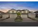 Stunning townhome features a private garage and beautiful Mediterranean-style architecture at sunset at 6065 Worsham Ln # 104, Bradenton, FL 34211