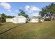 Exterior view of the house and large garage in the back yard with grass at 6116 Rodgers Ave, Sarasota, FL 34231