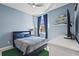 Comfortable bedroom with blue walls, carpet, and a window with lots of natural light at 6247 Champions Row St, Bradenton, FL 34210
