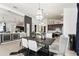 Dining room with modern light fixture and view of open kitchen and living space at 6247 Champions Row St, Bradenton, FL 34210