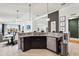 Eat-in kitchen with dark wood cabinets, granite counters, stainless appliances, and pendant lighting at 6247 Champions Row St, Bradenton, FL 34210