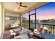 Screened lanai with comfortable seating and lake views, ideal for relaxing and entertaining guests at 6247 Champions Row St, Bradenton, FL 34210