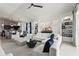 Open living room with white sofas and decor with views into the kitchen and dining area at 6247 Champions Row St, Bradenton, FL 34210