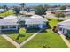 Aerial view of well-maintained homes with mature landscaping and manicured lawns in a sunny neighborhood at 7304 11Th W Ave, Bradenton, FL 34209