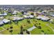 Aerial view of a lush neighborhood with mature trees and well-maintained lawns surrounding attractive homes at 7304 11Th W Ave, Bradenton, FL 34209