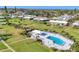 Aerial view of community featuring manicured lawns, community pool and surrounding landscape at 7304 11Th W Ave, Bradenton, FL 34209