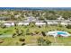 Aerial view showcasing community with well-maintained grounds, mature trees, a pool and manicured lawns at 7304 11Th W Ave, Bradenton, FL 34209