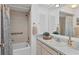 Bathroom with tiled shower and tub combination, plus vanity with marble countertop and ample mirror space at 7304 11Th W Ave, Bradenton, FL 34209