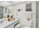 Bright bathroom featuring a vanity with ample counter space, decorative accents, and a well-lit mirror at 7304 11Th W Ave, Bradenton, FL 34209