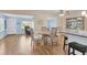Bright dining area with hardwood floors and a view of the sunroom, perfect for casual dining at 7304 11Th W Ave, Bradenton, FL 34209
