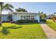 Charming single-story home with a well-manicured lawn and lush landscaping at 7304 11Th W Ave, Bradenton, FL 34209