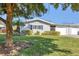 Charming single-story home featuring well-maintained landscaping, a lovely green lawn, and decorative shutters at 7304 11Th W Ave, Bradenton, FL 34209