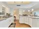 A sunlit kitchen features white cabinets, laminate countertops, mosaic backsplash, and modern stainless faucet and sink at 7304 11Th W Ave, Bradenton, FL 34209