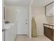 Functional laundry room with tile flooring, washer, dryer, and storage at 7304 11Th W Ave, Bradenton, FL 34209