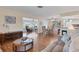 Open-concept living room with hardwood floors leading to the dining and sitting areas at 7304 11Th W Ave, Bradenton, FL 34209