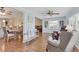 Open-concept living room with hardwood floors, ceiling fan, and plenty of natural light at 7304 11Th W Ave, Bradenton, FL 34209