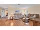 Cozy living room with hardwood floors, comfortable sofas, and ample natural light from the windows at 7304 11Th W Ave, Bradenton, FL 34209