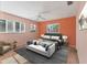 A sunlit primary bedroom with a modern color scheme, chair rail and decorative prints at 7304 11Th W Ave, Bradenton, FL 34209