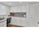 Bright office space with white cabinetry, work space and mosaic tile backsplash at 7304 11Th W Ave, Bradenton, FL 34209