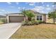 Charming home featuring a two-car garage, well-manicured landscaping, and a welcoming facade at 10605 58Th E St, Parrish, FL 34219