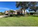 Charming home features lush lawn, mature trees, and well-maintained landscaping at 1269 Western Pine Cir, Sarasota, FL 34240