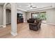 Inviting living room with ceiling fan, recessed lights, and sliding glass doors to pool area at 1269 Western Pine Cir, Sarasota, FL 34240