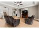 Relaxing living room features staircase and a TV with fireplace at 1269 Western Pine Cir, Sarasota, FL 34240