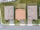 Aerial view of a home, showcasing its landscaped yard, roof, and proximity to neighboring houses at 13891 Heartwood Way, Parrish, FL 34219