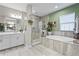 Spa-like bathroom offers a glass enclosed shower, soaking tub, and double sink vanity at 13891 Heartwood Way, Parrish, FL 34219
