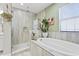 Elegant bathroom featuring a large bathtub, walk-in shower, and stylish tile work at 13891 Heartwood Way, Parrish, FL 34219