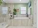 Bright bathroom with a large soaking tub, glass shower, and natural light at 13891 Heartwood Way, Parrish, FL 34219