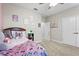 Cozy bedroom with carpet, a ceiling fan, closet, and charming decor at 13891 Heartwood Way, Parrish, FL 34219