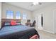 Well-lit bedroom with a ceiling fan, large window, and a dedicated study area at 13891 Heartwood Way, Parrish, FL 34219