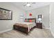 Traditional bedroom with a dark wood bed frame with drawers and colorful bedding and two art pieces at 13891 Heartwood Way, Parrish, FL 34219