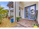 Inviting covered entryway features a blue double door, a welcome sign, and decorative plants at 13891 Heartwood Way, Parrish, FL 34219
