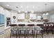 Modern kitchen featuring an island with seating, stainless steel appliances, and pendant lighting at 13891 Heartwood Way, Parrish, FL 34219