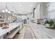 Bright, modern kitchen with white cabinetry, stainless steel appliances, and a stylish island with seating at 13891 Heartwood Way, Parrish, FL 34219