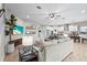 Inviting living room area with an open layout and seamless access to the modern kitchen space at 13891 Heartwood Way, Parrish, FL 34219