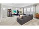 Spacious living room with a large sectional, television, and large bright windows with natural light at 13891 Heartwood Way, Parrish, FL 34219