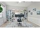 Bright home office with two monitors, book shelves, large rug and natural light from three windows at 13891 Heartwood Way, Parrish, FL 34219