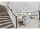 Open floorplan living area with a view of the kitchen and a staircase on the left at 13891 Heartwood Way, Parrish, FL 34219