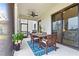 Inviting covered patio with dining table, chairs, and views of backyard and landscaping at 13891 Heartwood Way, Parrish, FL 34219