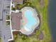 Aerial view of community pool and parking showcasing amenities and surrounding landscape at 13891 Heartwood Way, Parrish, FL 34219