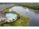 Aerial view of the community pool and splash fountain overlooking the community lake at 13891 Heartwood Way, Parrish, FL 34219