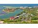 Stunning aerial shot of a coastal community, showcasing a luxury condo, tennis courts, and scenic bay views at 240 Sands Point Rd # 4201, Longboat Key, FL 34228