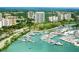 High-angle aerial view featuring a marina filled with boats and yachts in a coastal city at 240 Sands Point Rd # 4201, Longboat Key, FL 34228
