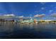 Picturesque marina view with yachts docked against a clear blue sky with fluffy clouds at 240 Sands Point Rd # 4201, Longboat Key, FL 34228